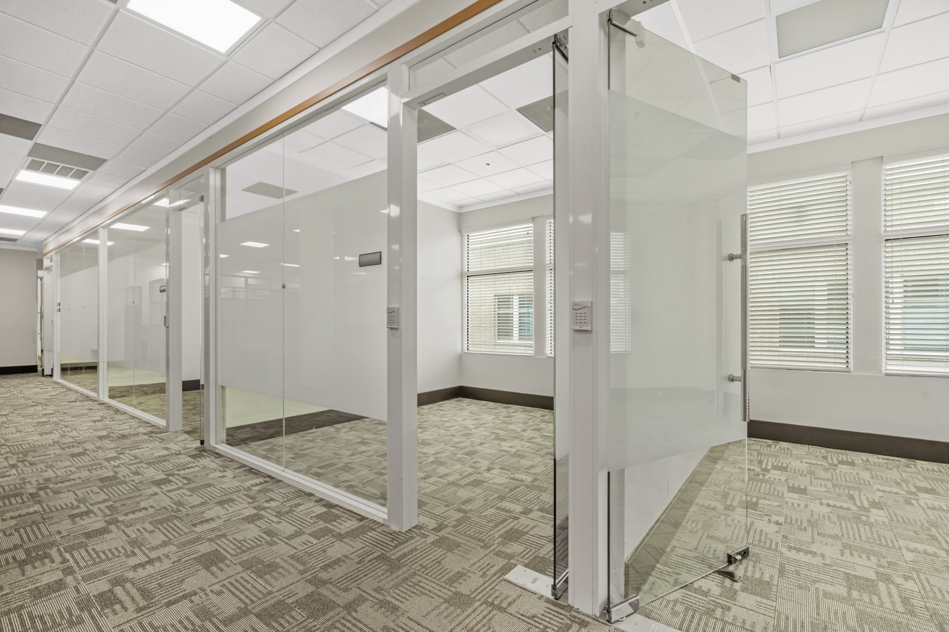 Glass-front offices along a corridor
