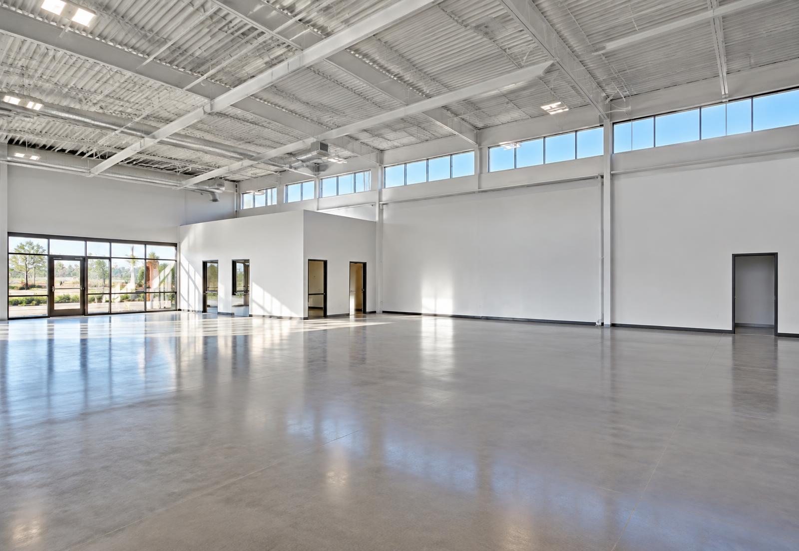 Empty shell space with polished concrete and clerestory daylight